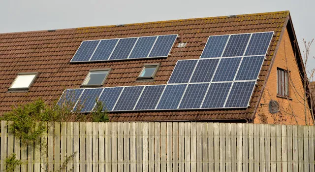 Two blocks of solar panels on the tiled roof of a house in Newtownards